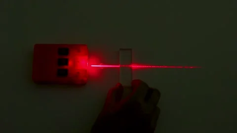 Red Laser Beam Refraction Physics Experiment with Glass Block Stock Footage 347255478