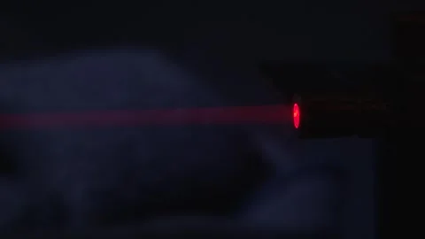 Red laser beam shining in complete darkness with a focused and high-tech Stock Footage 300431097