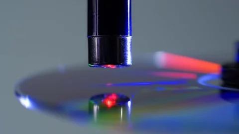 The red laser beam slides over the surface of the compact disk, reads the data Stock Footage
