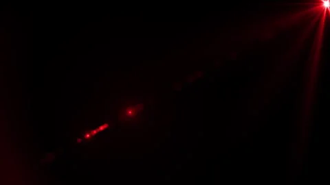 Red laser beams pierce through a dark background, creating a striking and Stock Footage 278140580