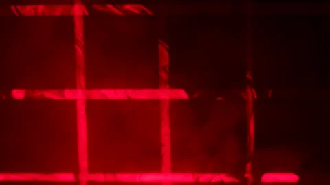Red laser beams from stage lights create a checkered pattern in a dark studio Stock Footage 168437091