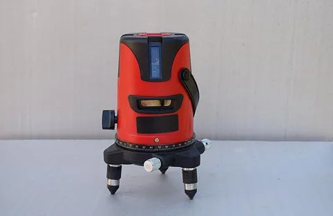 Red laser level tool on grey background Stock Photos