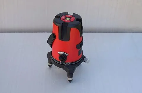 Red laser level tool on grey background 스톡 사진