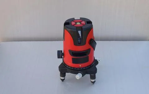 Red laser level tool on grey background Foto stock