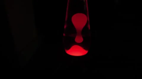 Red lava light in blacked out room dolly shot 4K Stock Footage 245772968