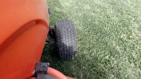 Red lawn tractor cutting the green grass. Stock Footage 74120414