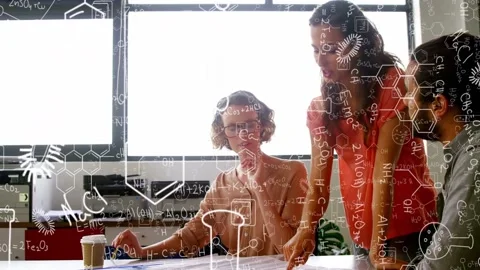 Red lead approaching, pointing; team leaning, gesturing, reviewing lab plans Stock Footage 334321998