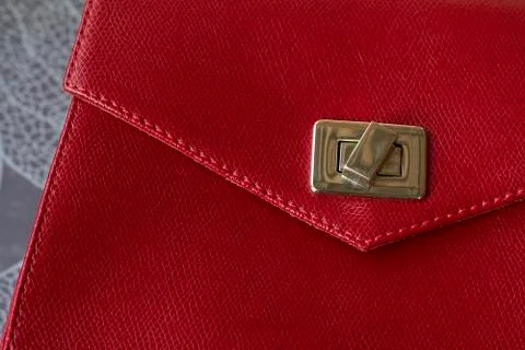 Red leather bag with gold elements on gray background. Free space for logo or Stock Photos
