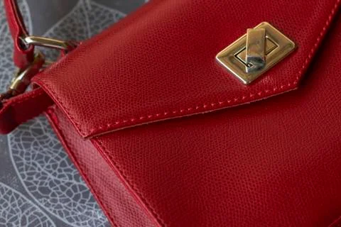 Red leather bag with gold elements on gray background. Free space for logo or Stock Photos
