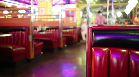 Red leather couch in modern restaurant and going waiter out of focus Video stock 62154019