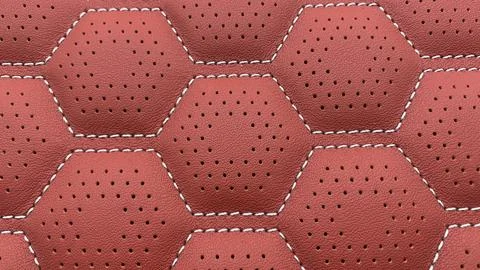 Red leather with a honeycomb pattern and small perforations, Foto stock