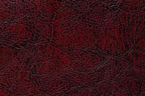 Red leather texture background, closeup. Ruby cracked backdrop from wrinkle s Stock Photos