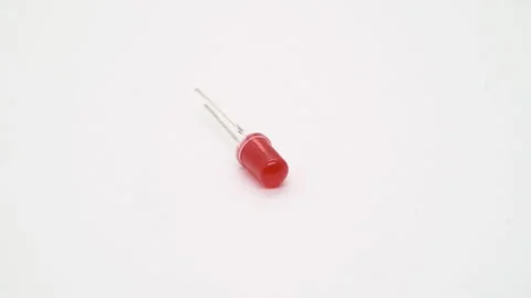 Red LED electronic component rotates on white background isolated. 스톡 동영상 169320304