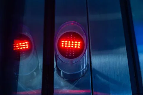 Red led indicator light signal on a metallic industrial panel surface 写真素材
