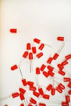 Red LED lamps. A scattering of electronic elements. Light-emitting diodes. Stock Photos