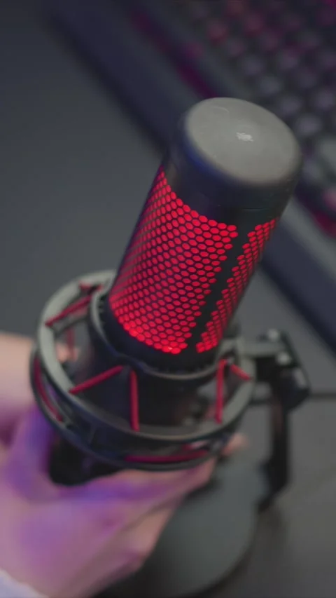 Red LED Microphone Held by Hand Near Computer Peripherals Close Up with hexagon Stock Footage 348031892