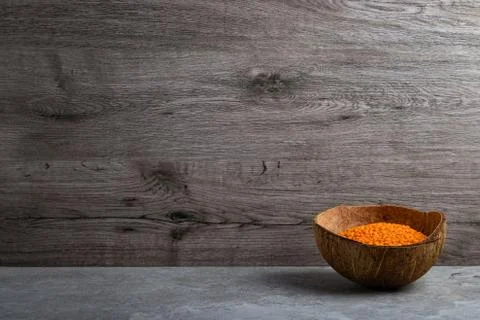 Red lentils in coconut shell Stock Photos