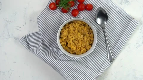 Red lentils in a deep dish top view. Steam from the plate. Stock Footage 139511632