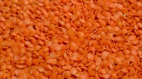 Red lentils raw ingredient being scooped with spoon, 4K Stock Footage 67543084
