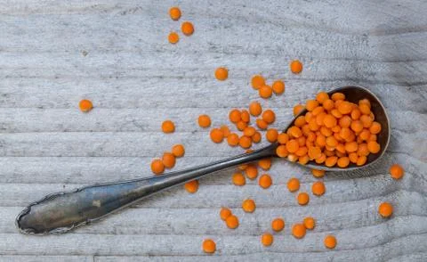 Red lentils on a spoon macro Stock Photos