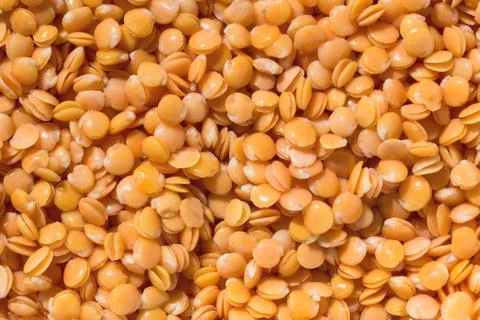 Red lentils texture background. Close-up healthy organic lentil seed. Natural Stock Photos