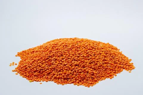 Red lentils on a white background. Stock Photos