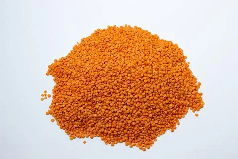 Red lentils on a white background. Stock Photos
