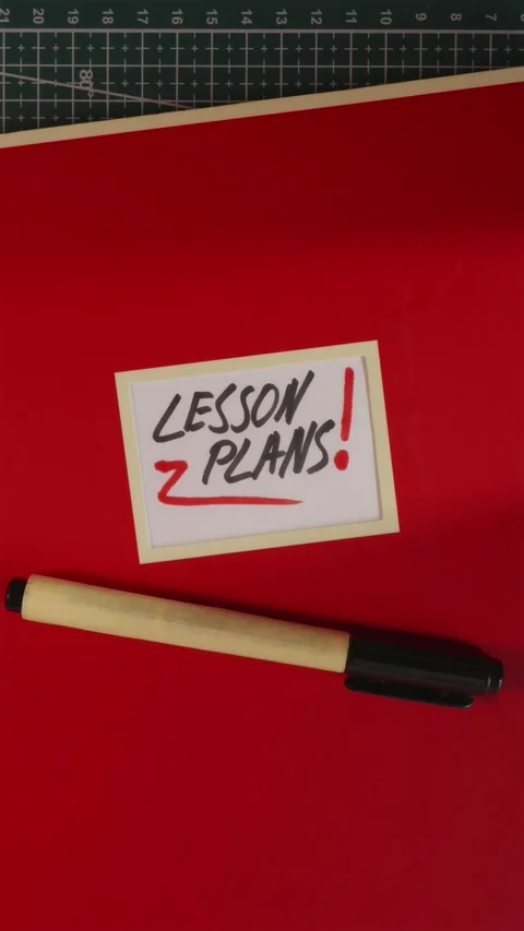 Red Lesson Plans notebook folder flat lay on wooden table Stock Footage 341246051
