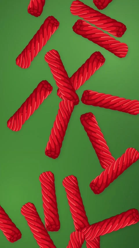 Red Licorice Candy Falling Over Green Mesh Background Vertical Animation Stock Footage 344851002