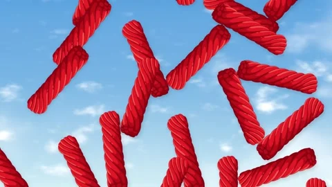 Red Licorice Twists Falling Through a Bright Blue Sky Stockbeeldmateriaal 344936470