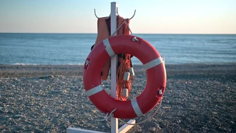 Red lifebuoy on an empty beach Stock Footage 194413192