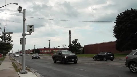 Red light camera picture and video two cameras on silver post with traffic Stock Footage 247753388