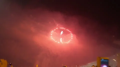 Red light covering night sky as fireworks exploding outdoors in city. Wide shot Stock Footage 237443085