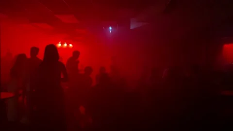 Red light dark room full of people on a party. Stock Footage 207658518