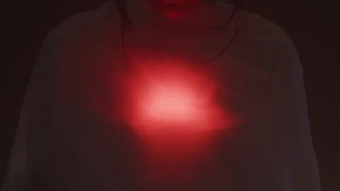 A Red Light Flashes Through a Sheet on a Women's Chest Видео 270388985
