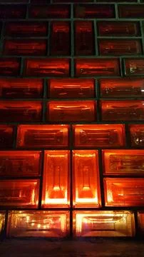 Red light going through a wall of glass tiles Stock Photos