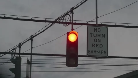 A red light on a local street with a no turn sign at dusk Stockbeeldmateriaal 333524318