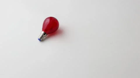 The red light rolls on a white background and then stops in place Stock Footage