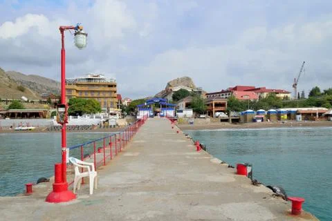 The red light on sea pier Sudak Stock Photos