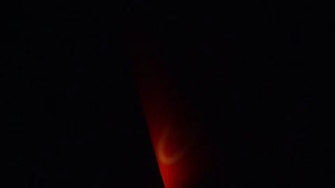 Red light shining behind silhouette of object Video stock 121447507