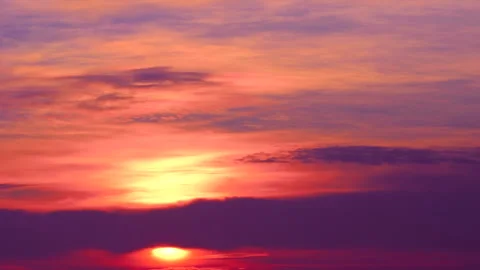 Red light of sunrise on the sky background. Beautiful purple and pink clouds. Stock Footage 240240244