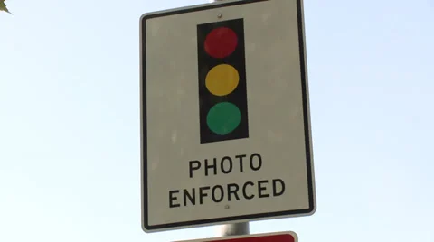 Red light traffic camera enforced sign quick pan 1080 1920x1080 high definition Stock Footage 32880343