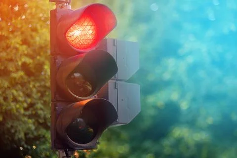 Red light of traffic lights in summer city Stock Photos