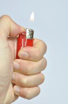 Red lighter in hand Photos
