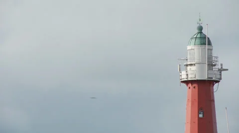 Red lighthouse against slightly cloudy sky Vídeo Stock 37168231