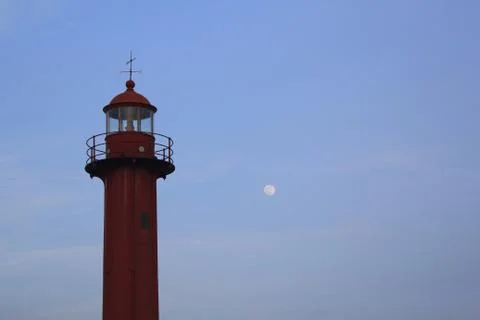 Red lighthouse and a full moon Stock Photos