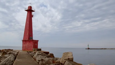 Red Lighthouse and rocks at Pere Marquette, Michigan. Panning shot. 4k60p Stock Footage 128859154