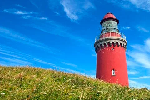 Red lighthouse in beachgrass Stock Photos