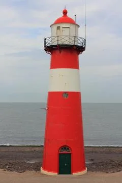 A red lighthouse with blue sky in the background Stock Photos