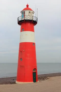 A red lighthouse with blue sky in the background Stock Photos